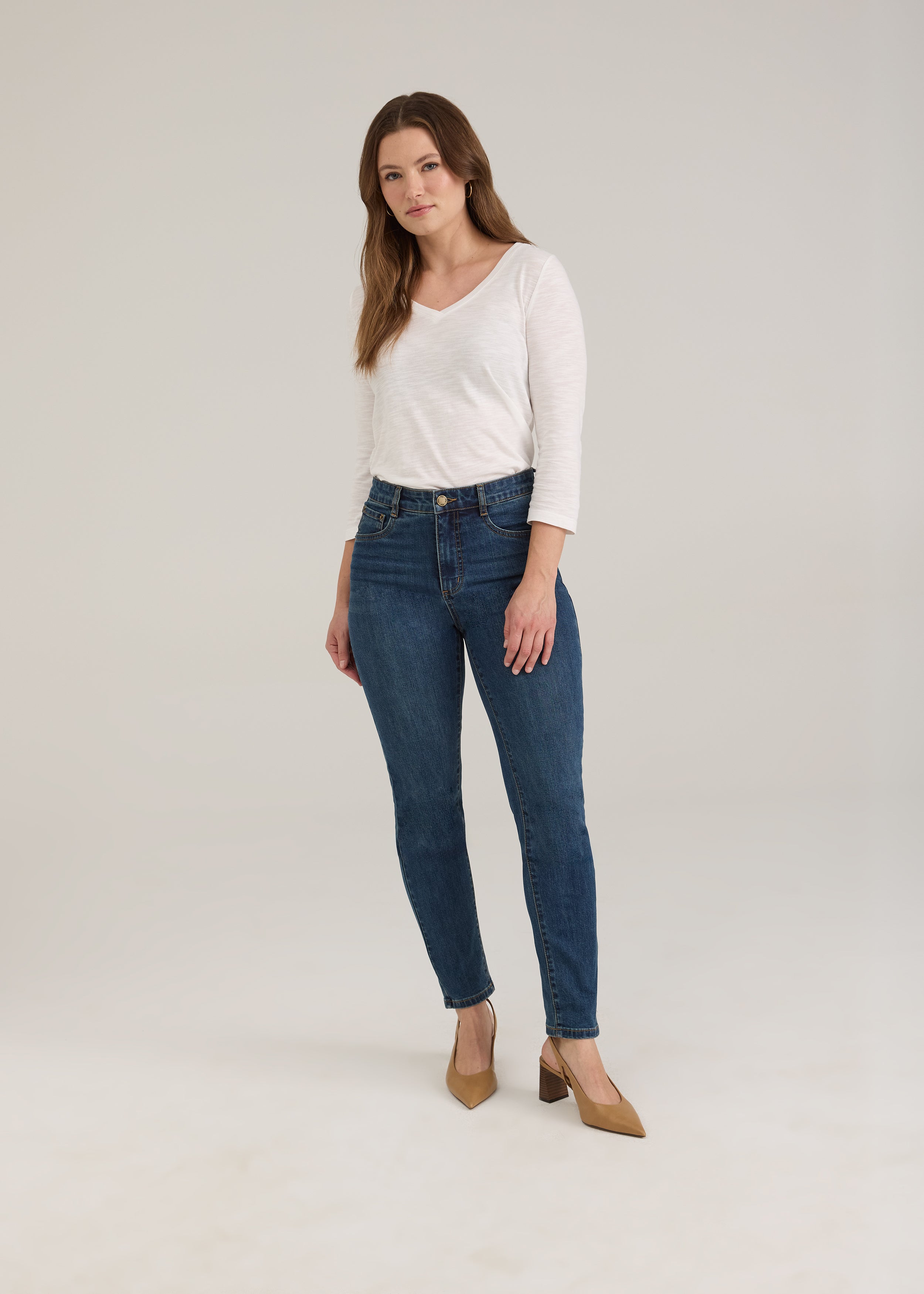 Full view of woman wearing dark wash slim leg jeans with high-rise by French Dressing Jeans (FDJ)