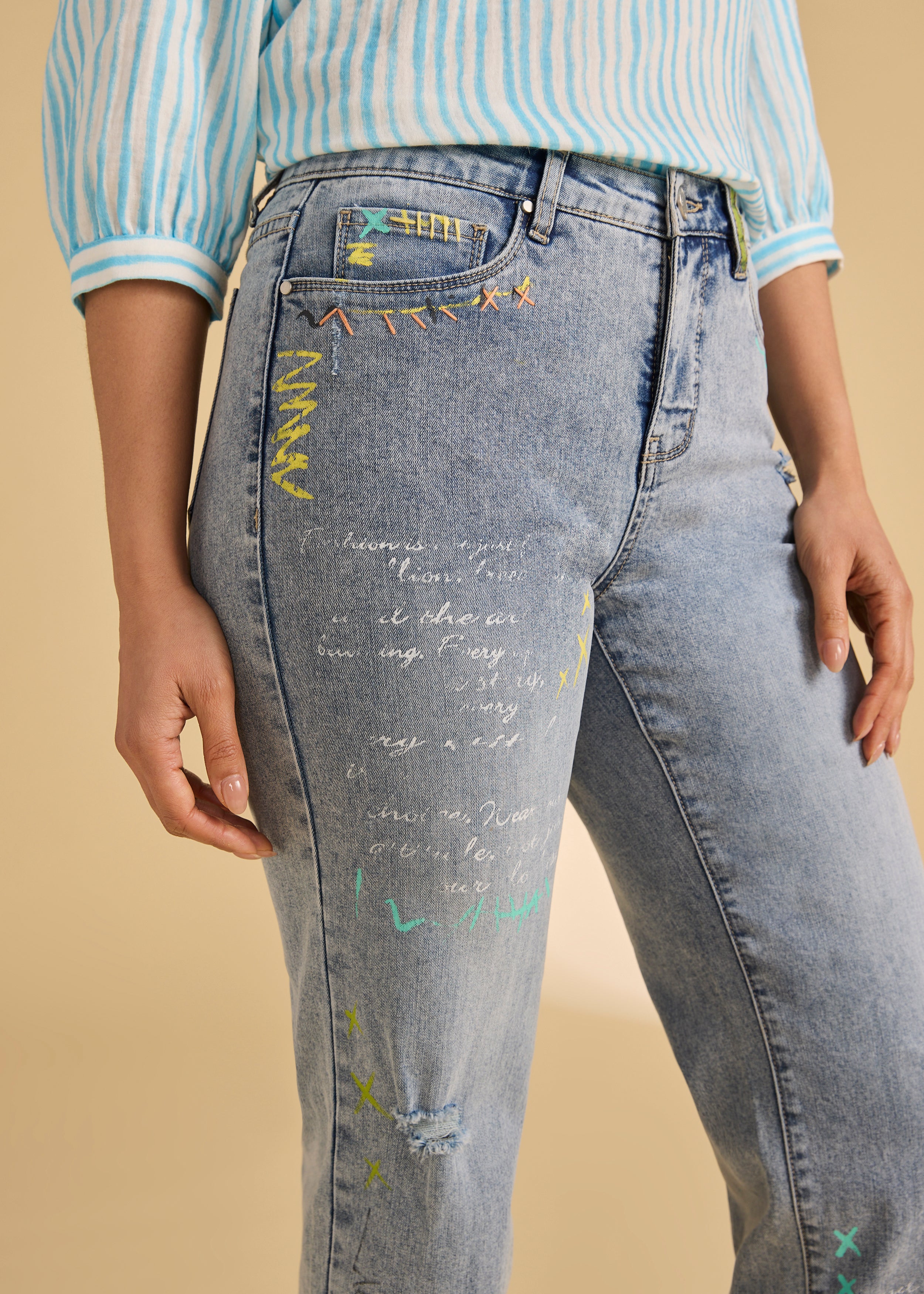 Close-up of colorful embroidery on ocean denim jeans by French Dressing Jeans (FDJ)