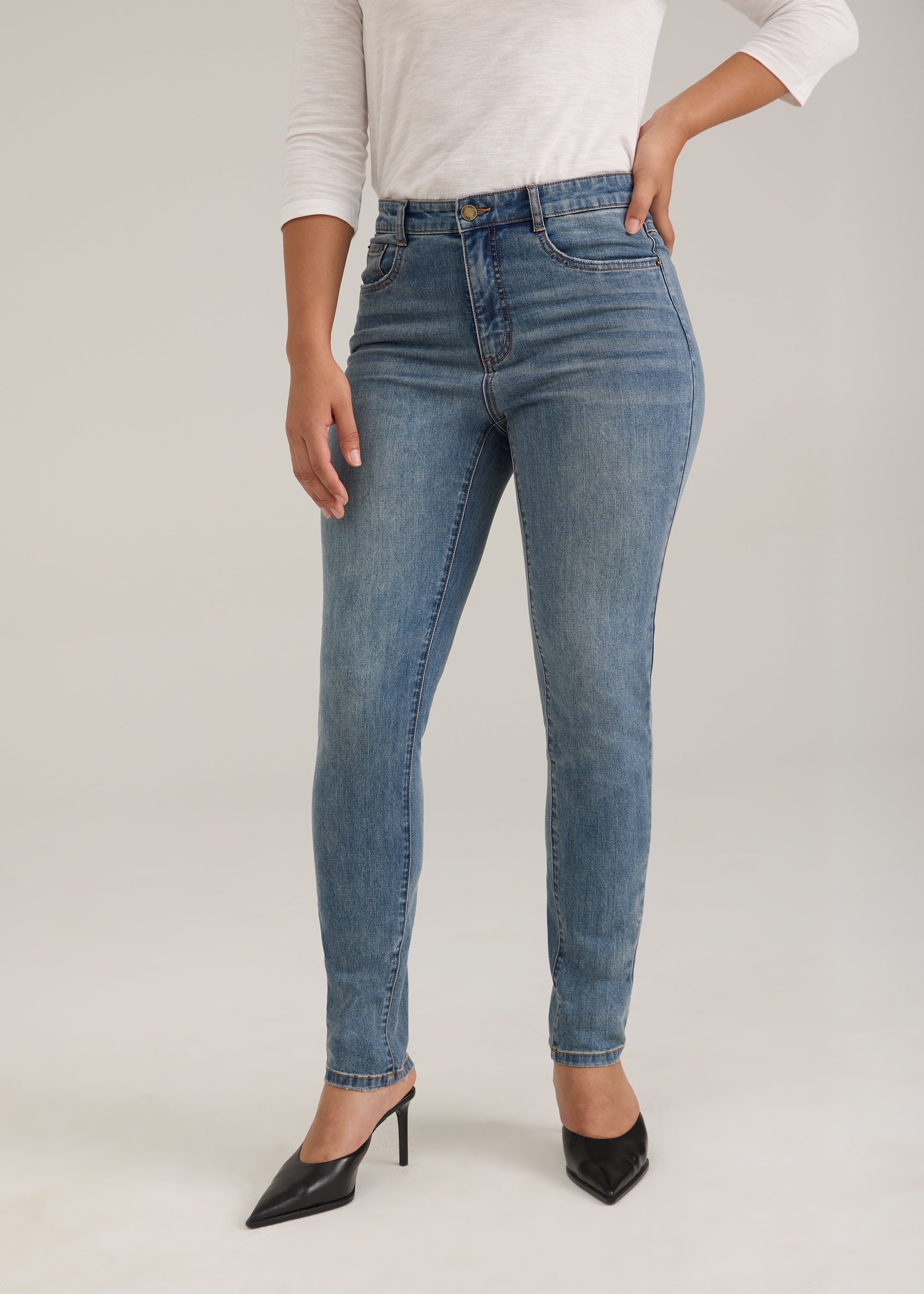 Front view of light wash slim leg jeans with high-rise waist by French Dressing Jeans (FDJ)