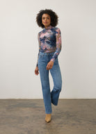 Full body view of abstract blue and pink print top with denim jeans, chic casual style by French Dressing Jeans (FDJ)