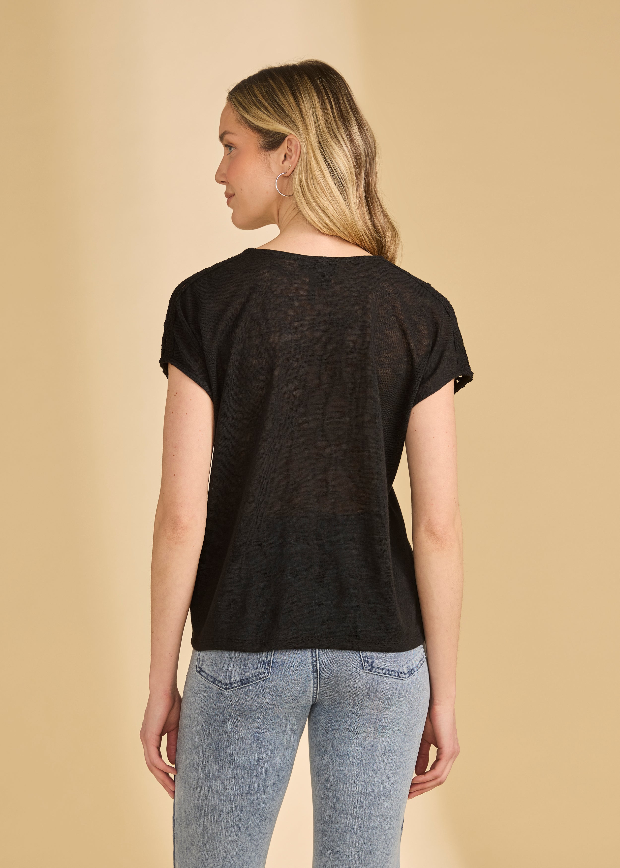 Back view of black V-neck top highlighting crochet shoulder details by French Dressing Jeans (FDJ)
