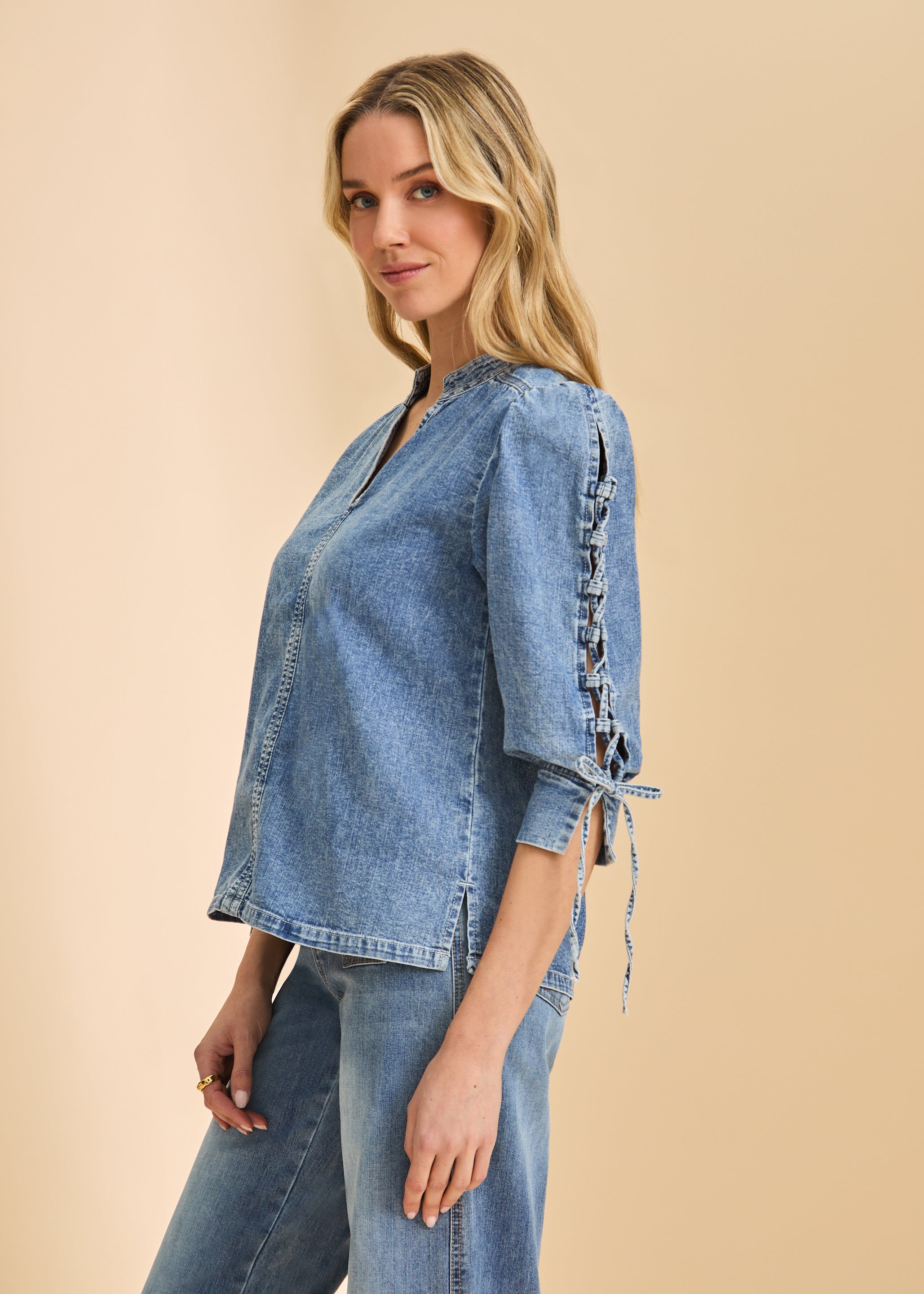 Side profile of chambray shirt emphasizing lace-up sleeve design by French Dressing Jeans (FDJ)