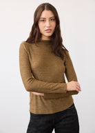 Front view of gold shimmer top with long sleeves and fitted design by French Dressing Jeans (FDJ)
