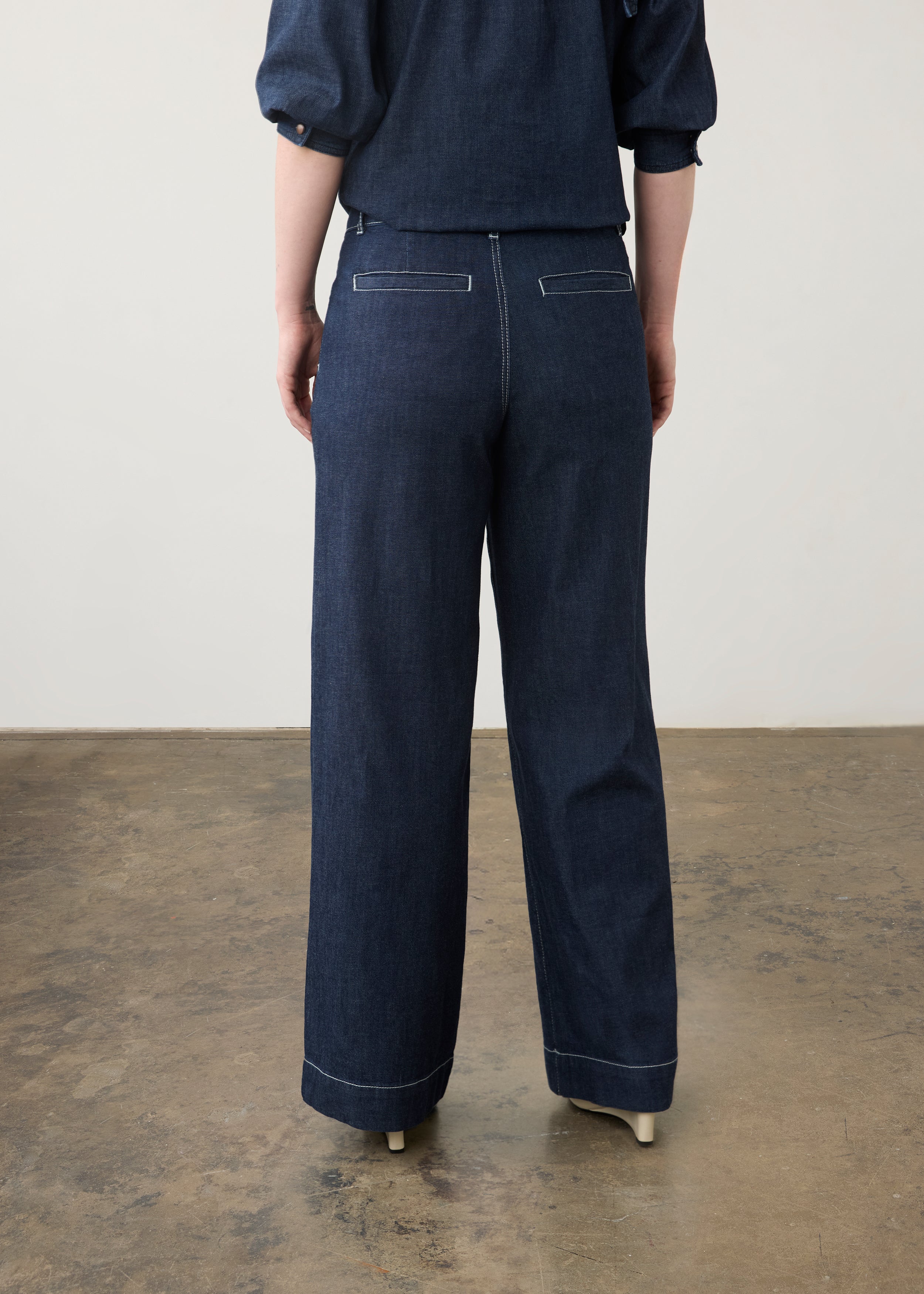 Back view of dark wash wide-leg pants with welt pockets and cropped top by French Dressing Jeans (FDJ)