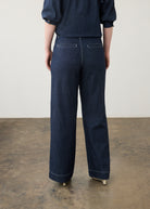 Back view of dark wash wide-leg pants with welt pockets and cropped top by French Dressing Jeans (FDJ)