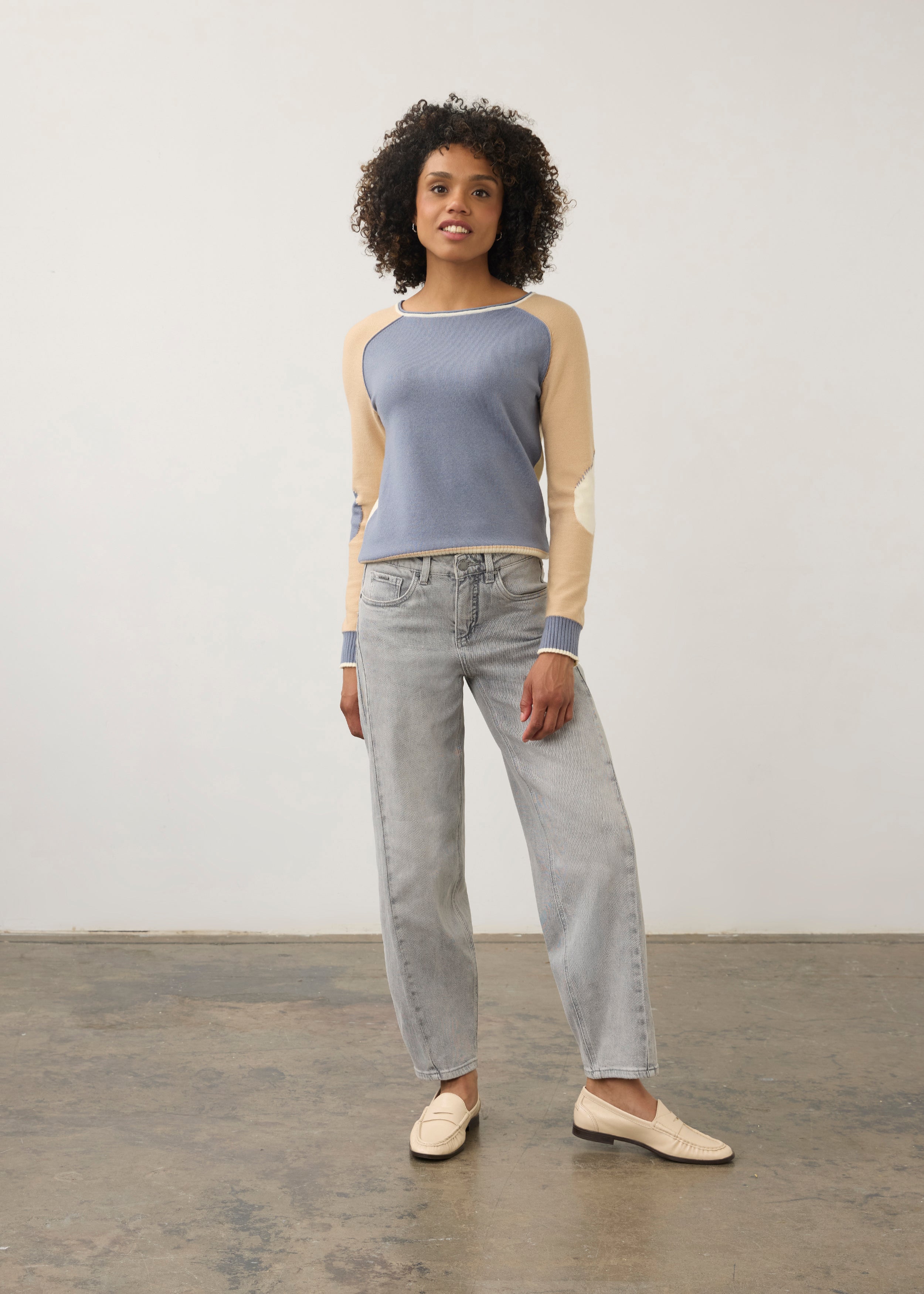 Model in colorblock sweater with light denim jeans, full outfit view by French Dressing Jeans (FDJ)