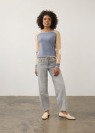 Model in colorblock sweater with light denim jeans, full outfit view by French Dressing Jeans (FDJ)