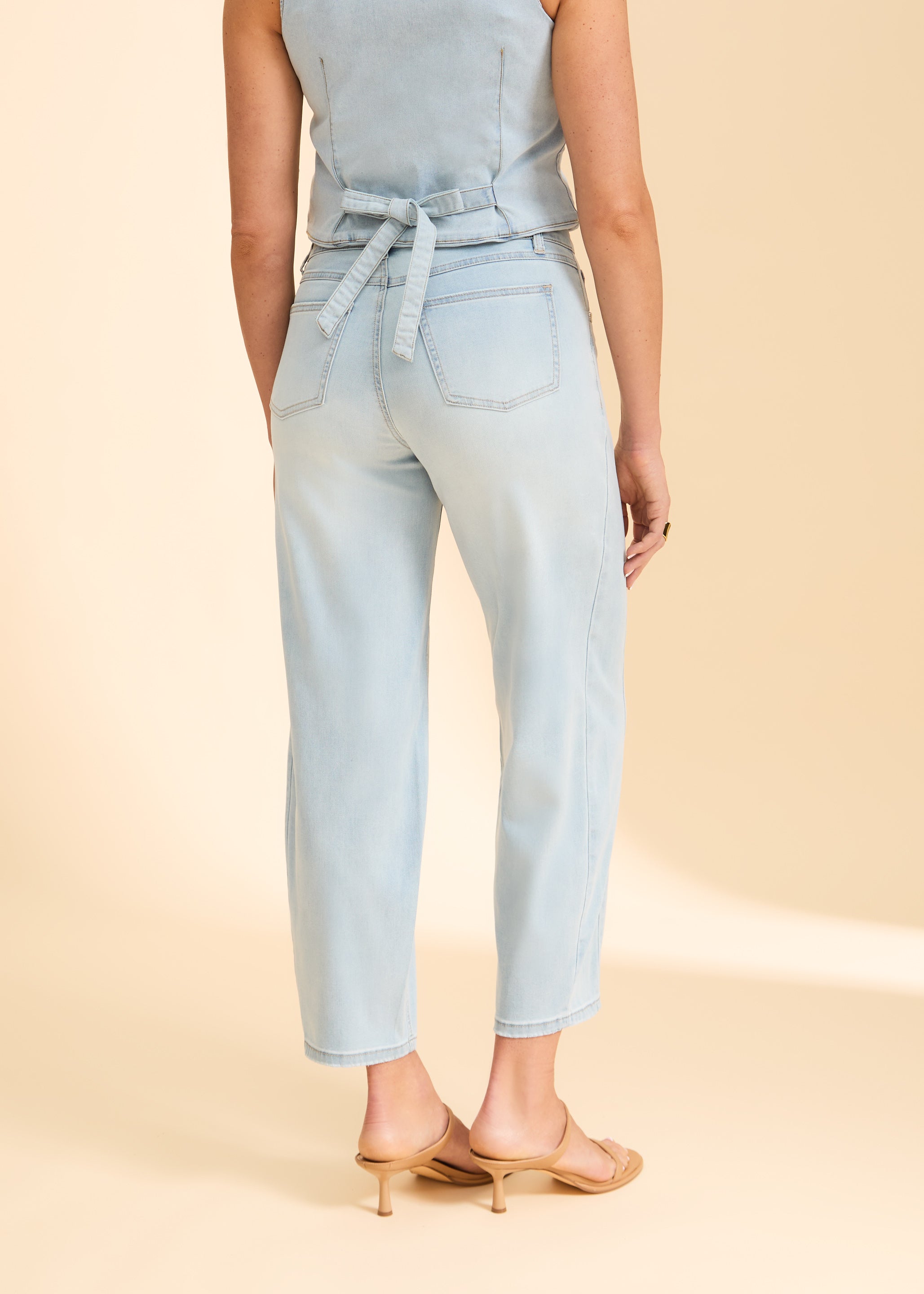 Back view of light wash denim jeans with tied waist detail and pockets by French Dressing Jeans (FDJ)