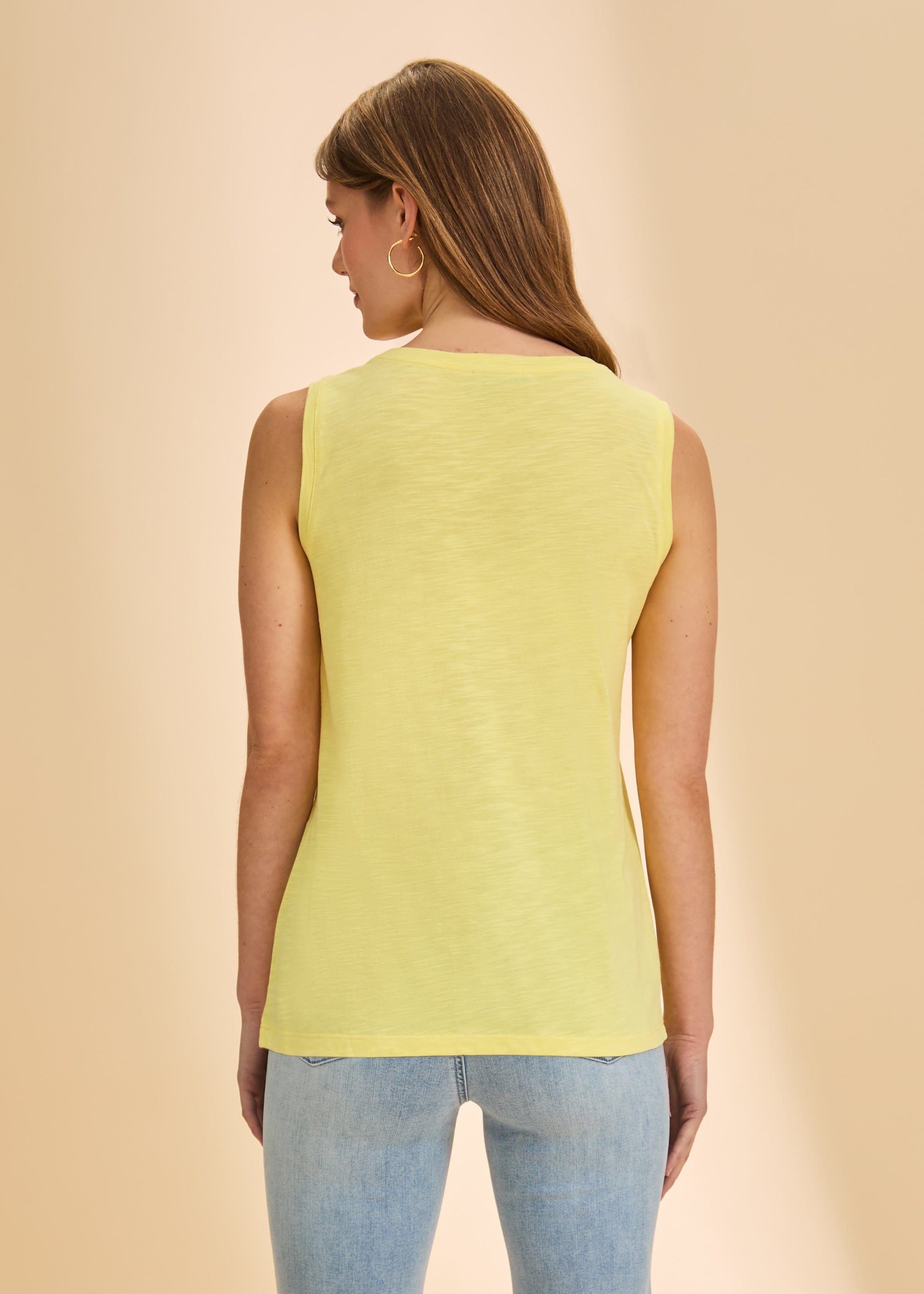 Back view of yellow sleeveless top showing simple, bright design by French Dressing Jeans (FDJ)