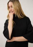 Close-up of black tunic sweater highlighting ribbed sleeve detail by French Dressing Jeans (FDJ)