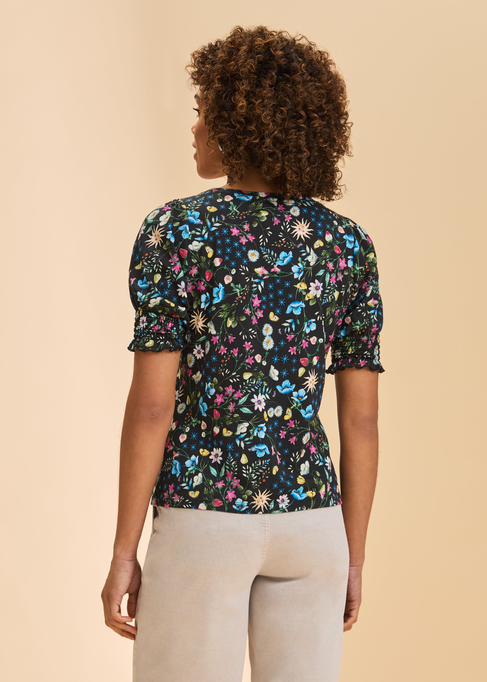 Back view of black floral top showing smocked sleeves and vibrant pattern by French Dressing Jeans (FDJ)