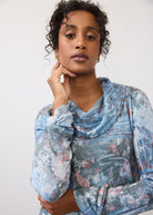 Close-up of indigo cowl neck top showcasing soft fabric and floral pattern by French Dressing Jeans (FDJ)