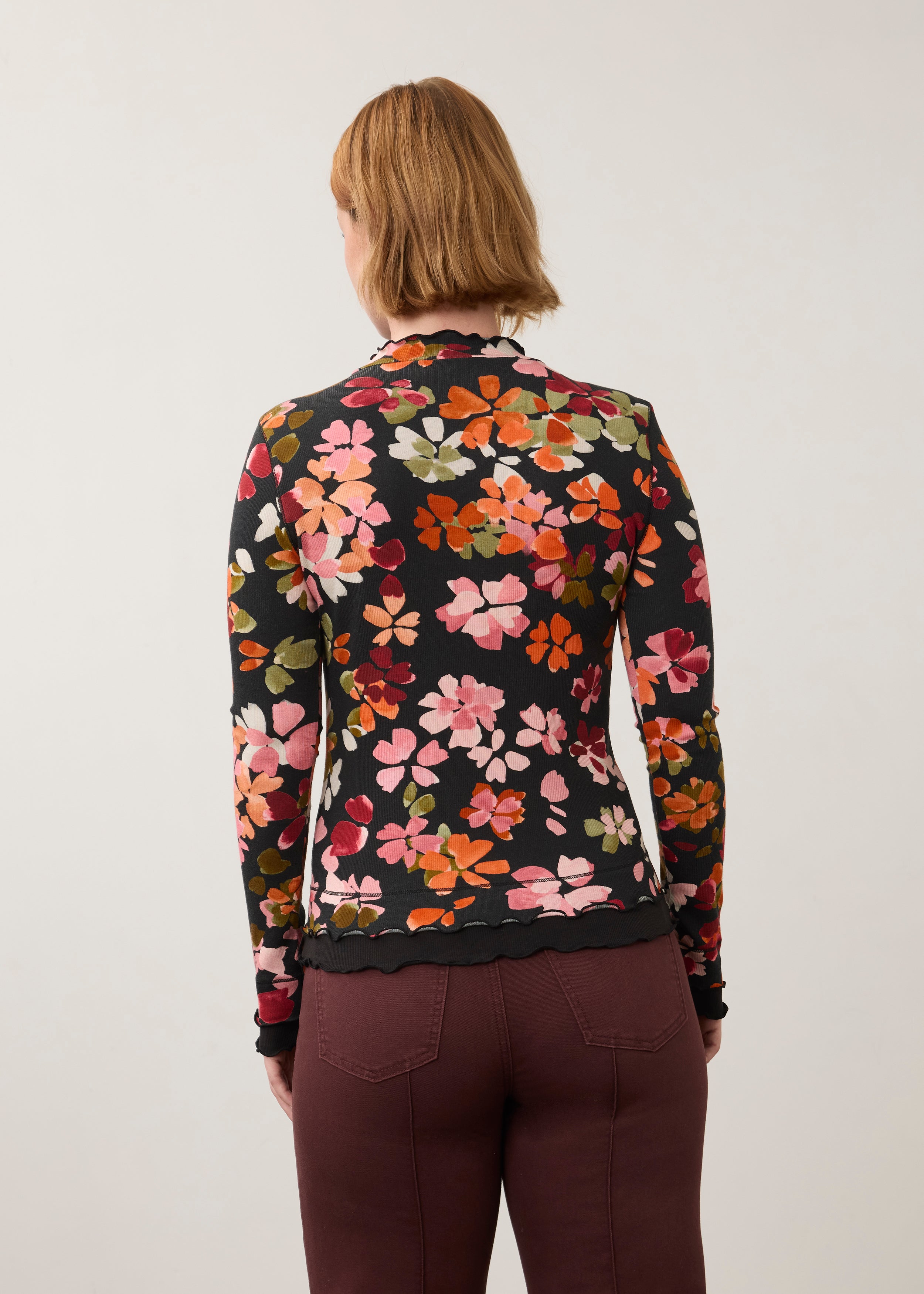 Back view of vibrant floral top, highlighting seamless design and ruffled edges by French Dressing Jeans (FDJ)