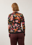 Back view of vibrant floral top, highlighting seamless design and ruffled edges by French Dressing Jeans (FDJ)