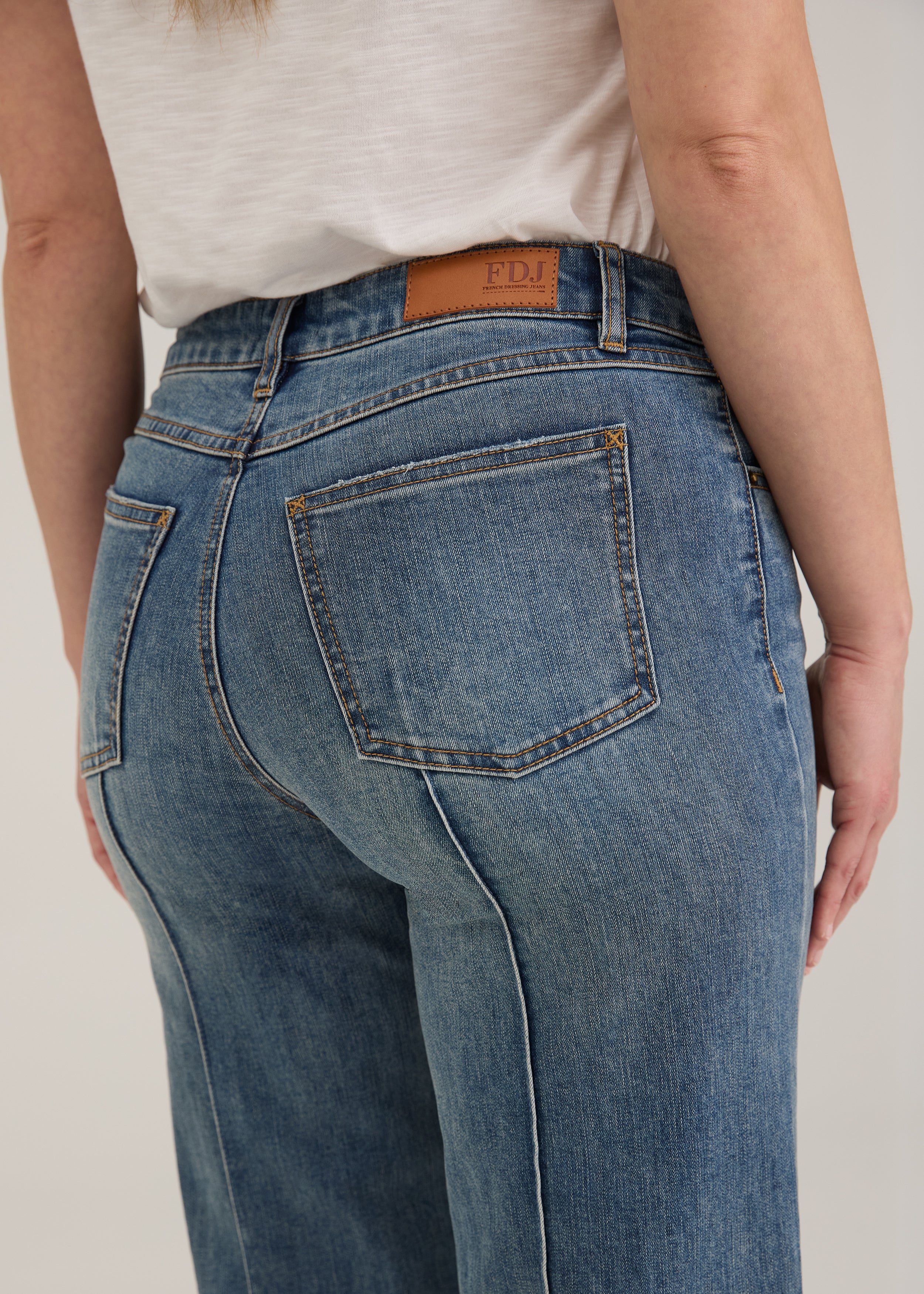 Detail shot of back pockets and waistline on light wash Olivia denim by French Dressing Jeans (FDJ)