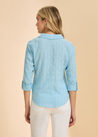 Back view of light blue textured shirt showing pattern and rolled cuffs by French Dressing Jeans (FDJ)
