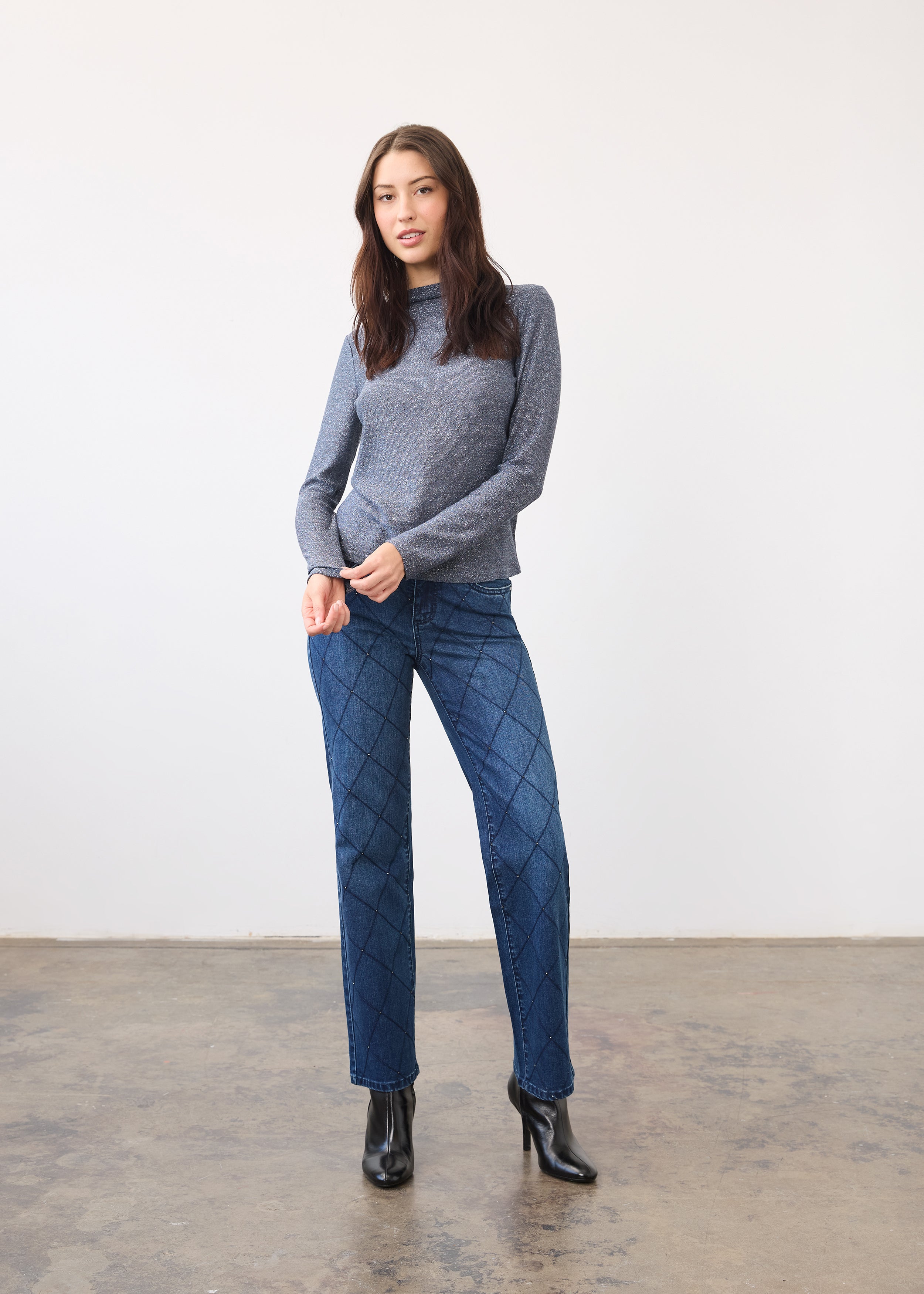 Full view of blue shimmer top paired with patterned jeans and black boots by French Dressing Jeans (FDJ)