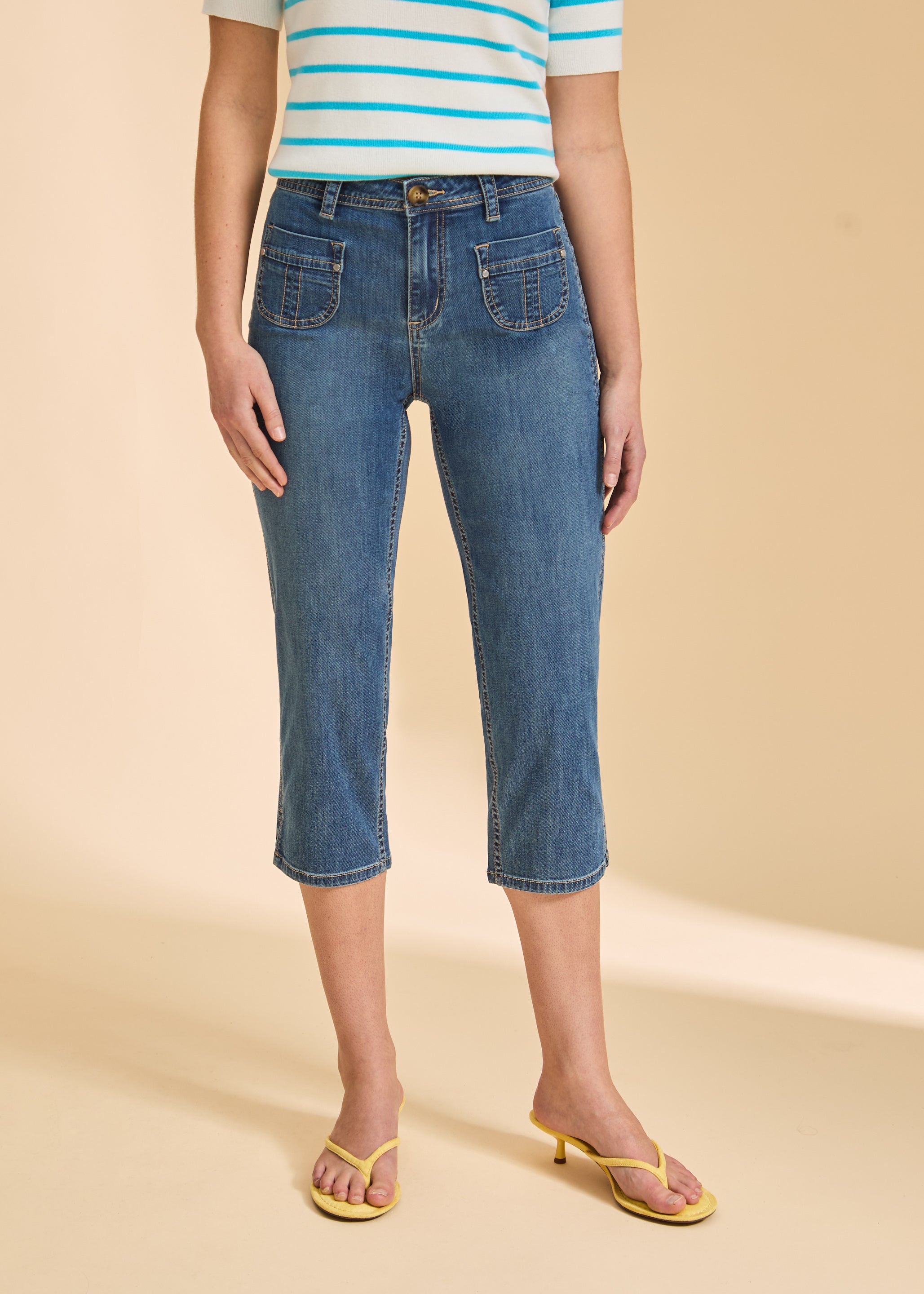Close-up of medium wash cropped jeans highlighting pocket details by French Dressing Jeans (FDJ)
