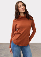 Front view of rust sweater with cowl neck and front pockets by French Dressing Jeans (FDJ)