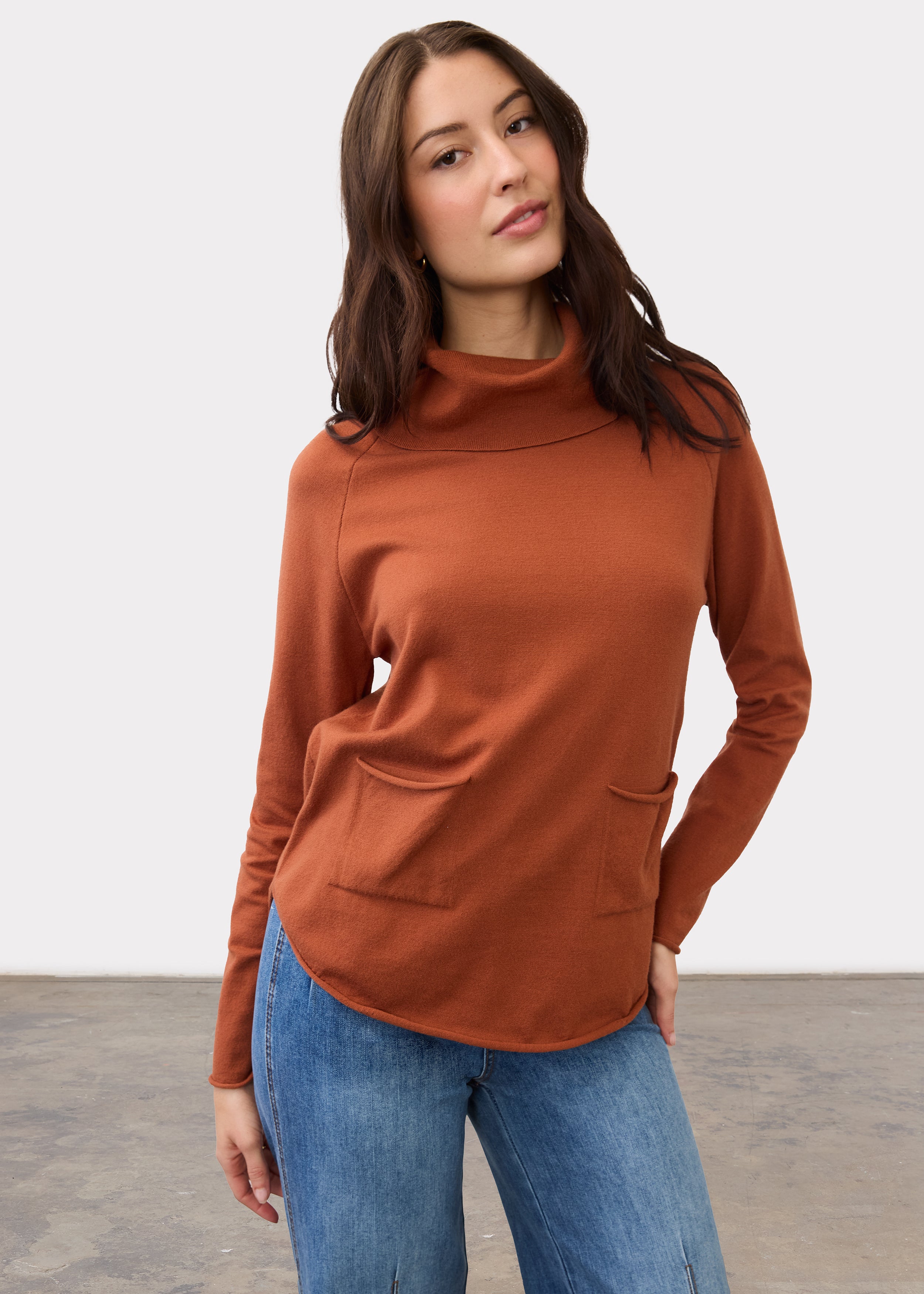 Front view of rust sweater with cowl neck and front pockets by French Dressing Jeans (FDJ)