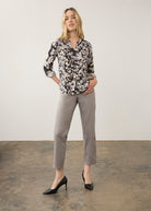 Full body view of model in floral printed shirt and grey pants by French Dressing Jeans (FDJ)