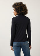 Back view of black turtleneck top highlighting smooth fabric and seamless design by French Dressing Jeans (FDJ)