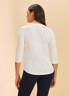 Back view of white V-neck 3/4 sleeve top showcasing versatile design by French Dressing Jeans (FDJ)