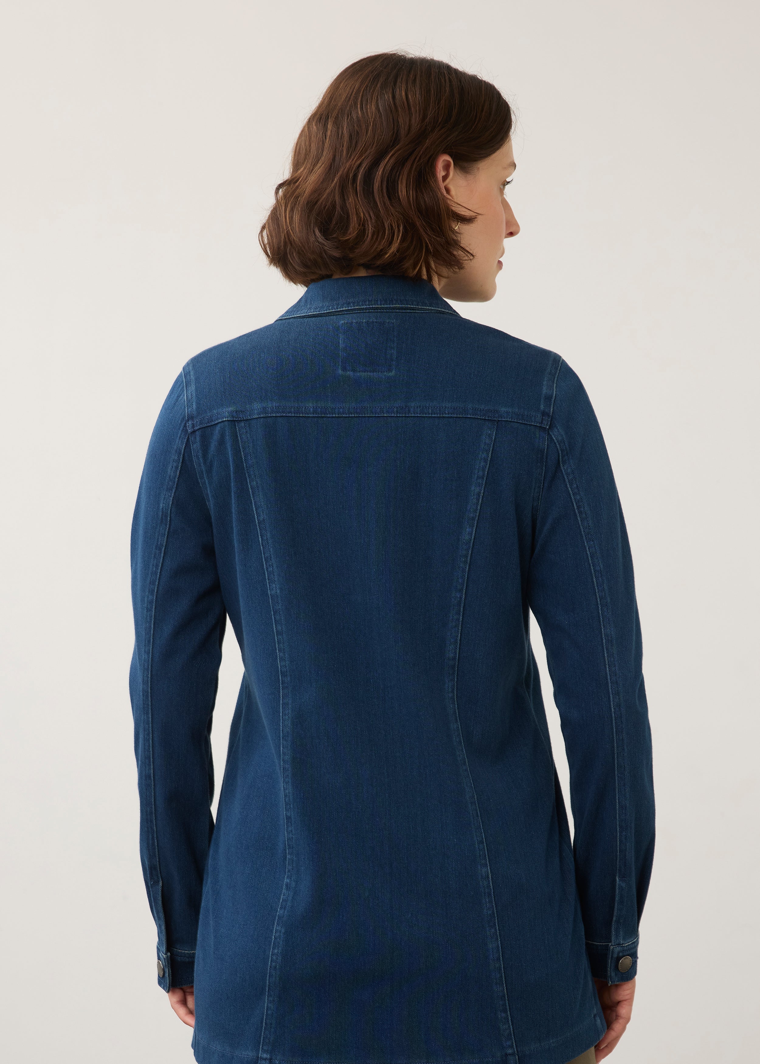 Back view of dark rinse long button-down jacket highlighting seam lines and fit by French Dressing Jeans (FDJ)