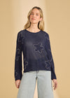Front view of navy sweater with floral embellishments and sheer knit by French Dressing Jeans (FDJ)