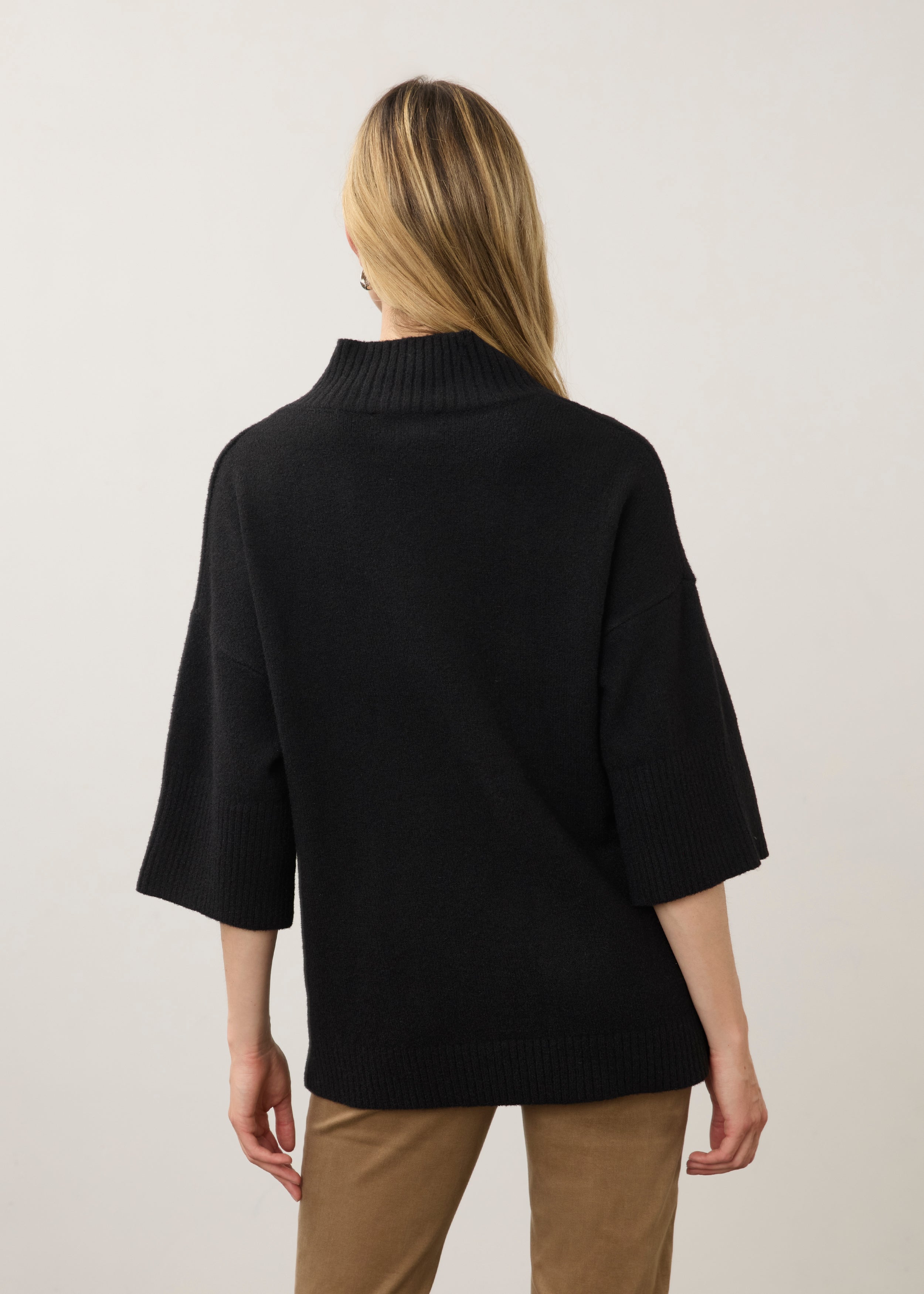 Back view of black tunic sweater showcasing relaxed fit and ribbed collar by French Dressing Jeans (FDJ)