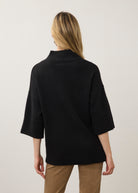 Back view of black tunic sweater showcasing relaxed fit and ribbed collar by French Dressing Jeans (FDJ)