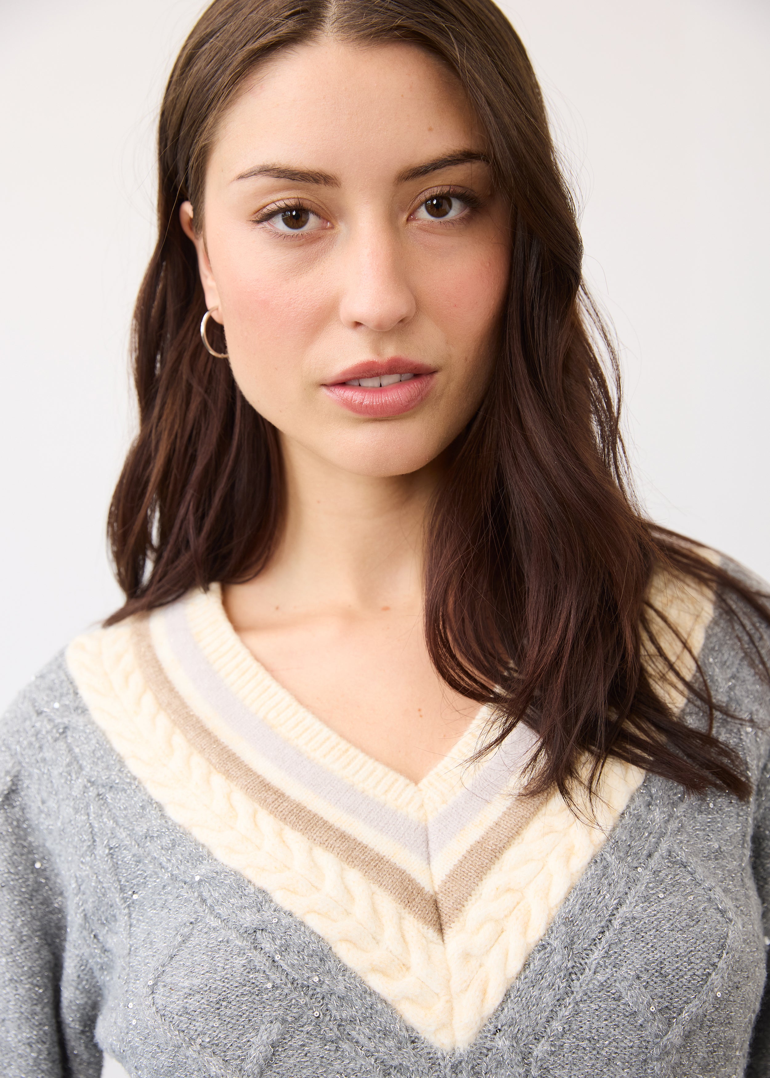 Detail of V-neck and sparkle texture on gray sweater showcasing shimmer by French Dressing Jeans (FDJ)