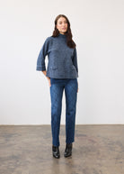 Full view of textured indigo top paired with patterned jeans and black boots by French Dressing Jeans (FDJ)