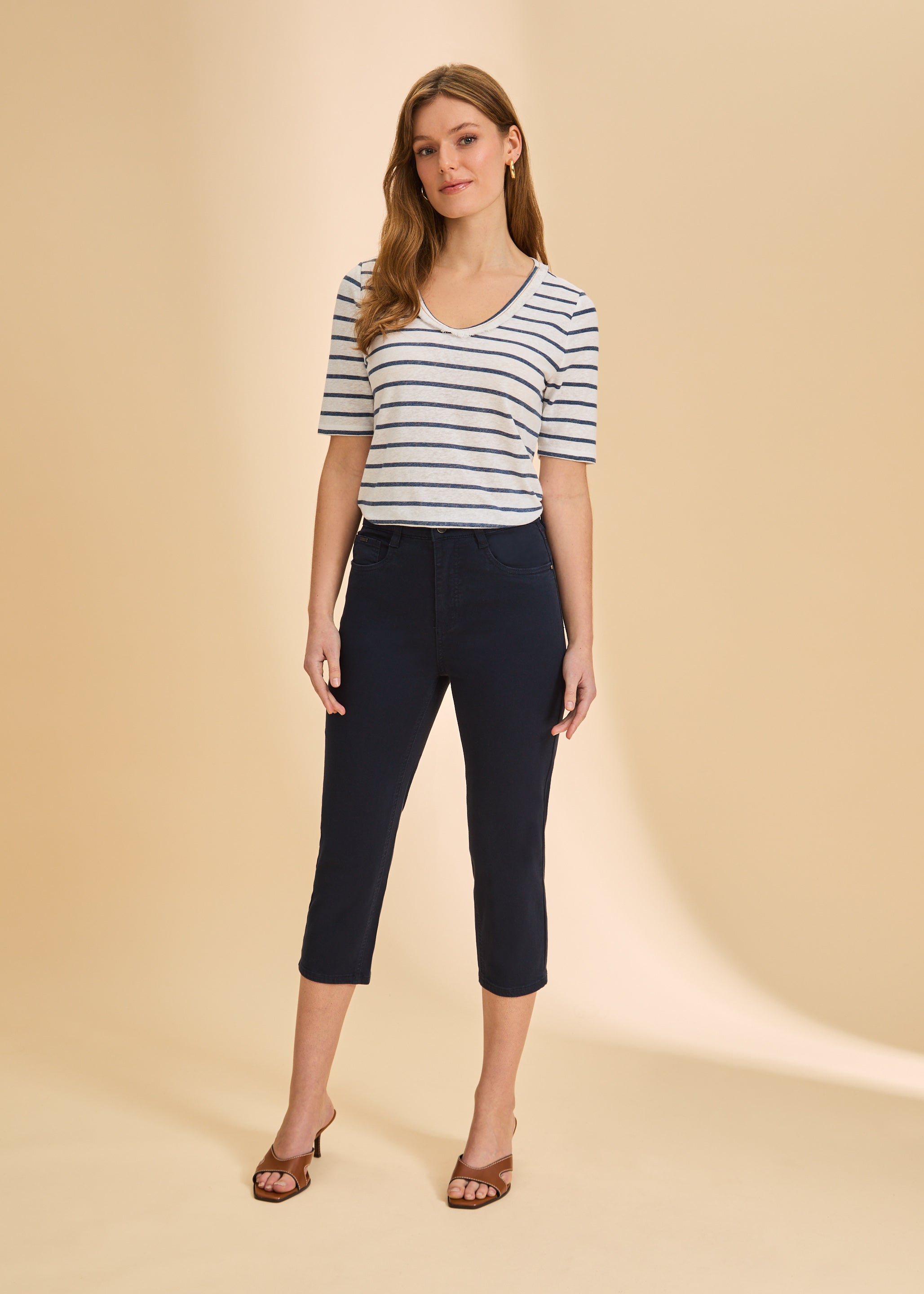Full outfit with blue striped V-neck top and dark pants for a sleek look by French Dressing Jeans (FDJ)