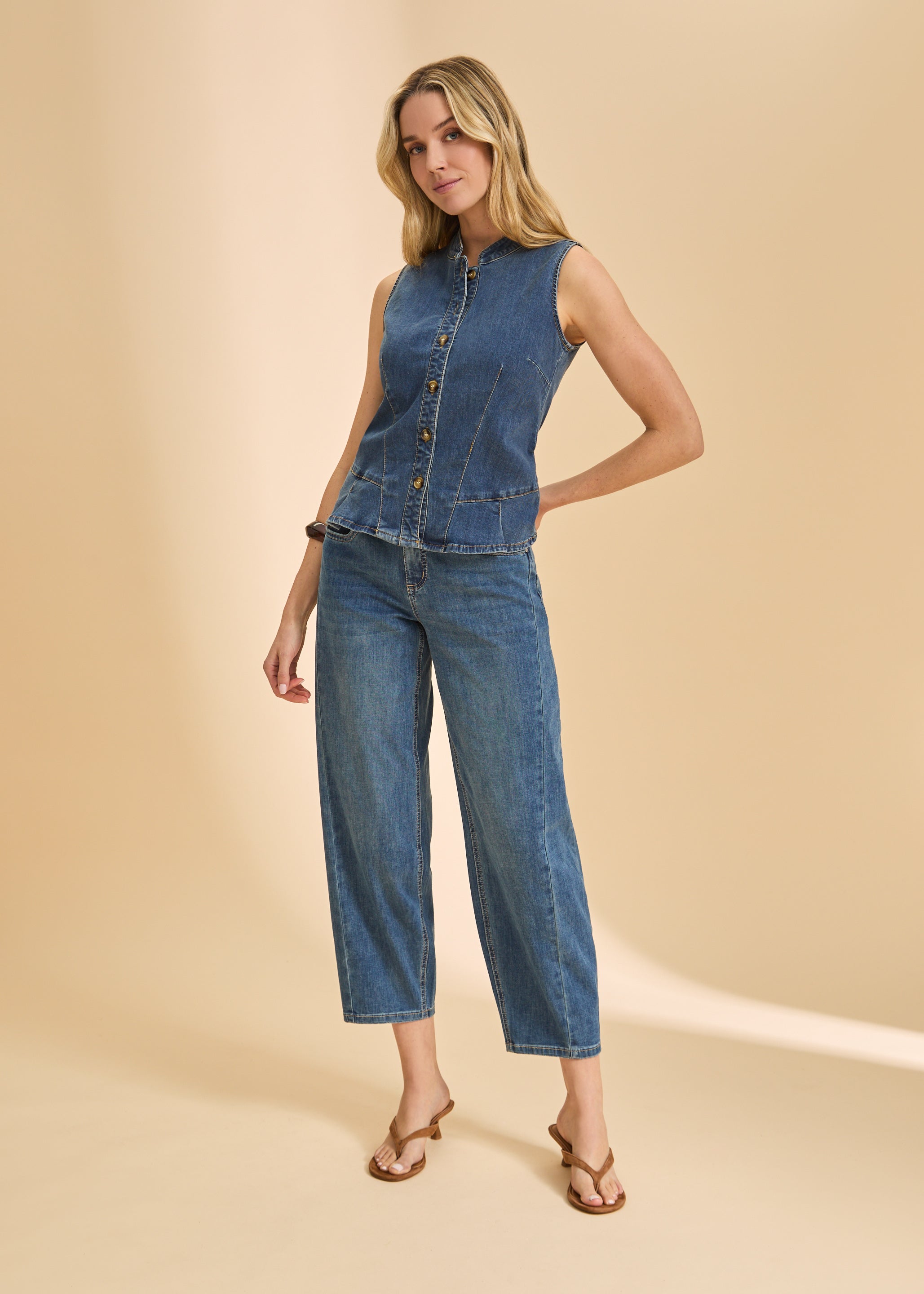 Full body view of dark wash denim ensemble with sleeveless top and wide-leg jeans by French Dressing Jeans (FDJ)