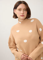 Close-up of tan polka dot sweater with high collar detail by French Dressing Jeans (FDJ)