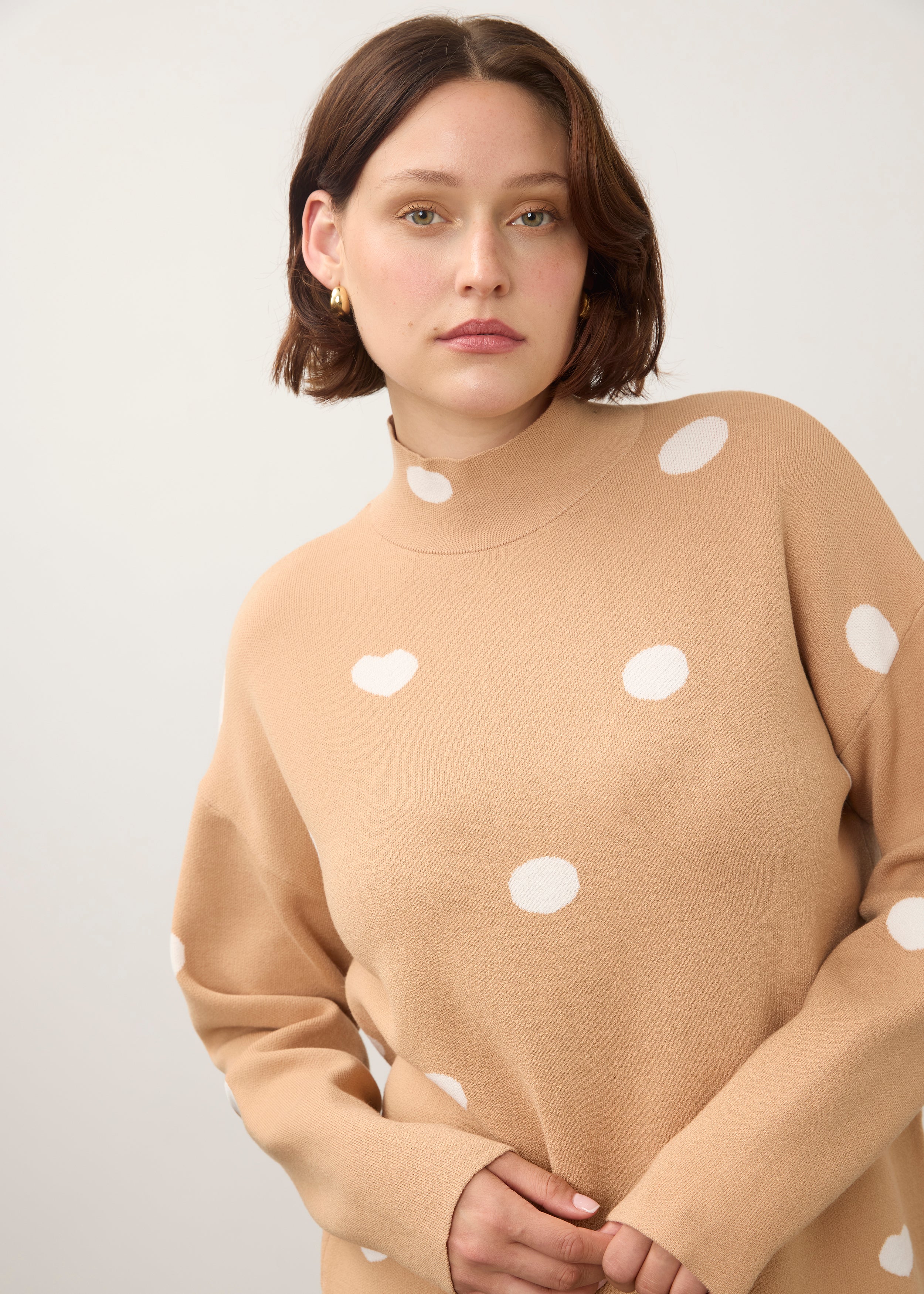 Close-up of tan polka dot sweater with high collar detail by French Dressing Jeans (FDJ)