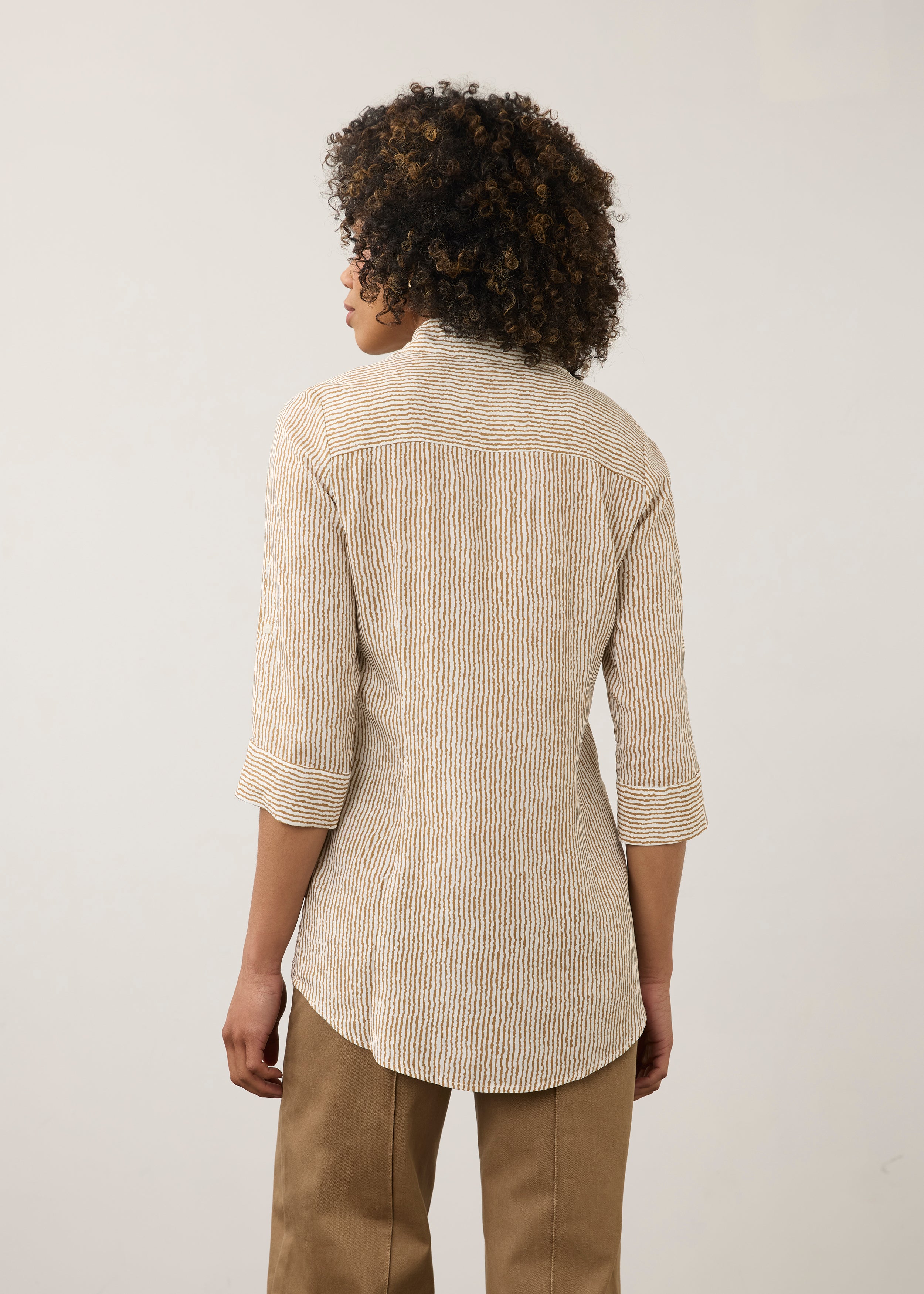 Back view of striped beige and white shirt highlighting long sleeves by French Dressing Jeans (FDJ)