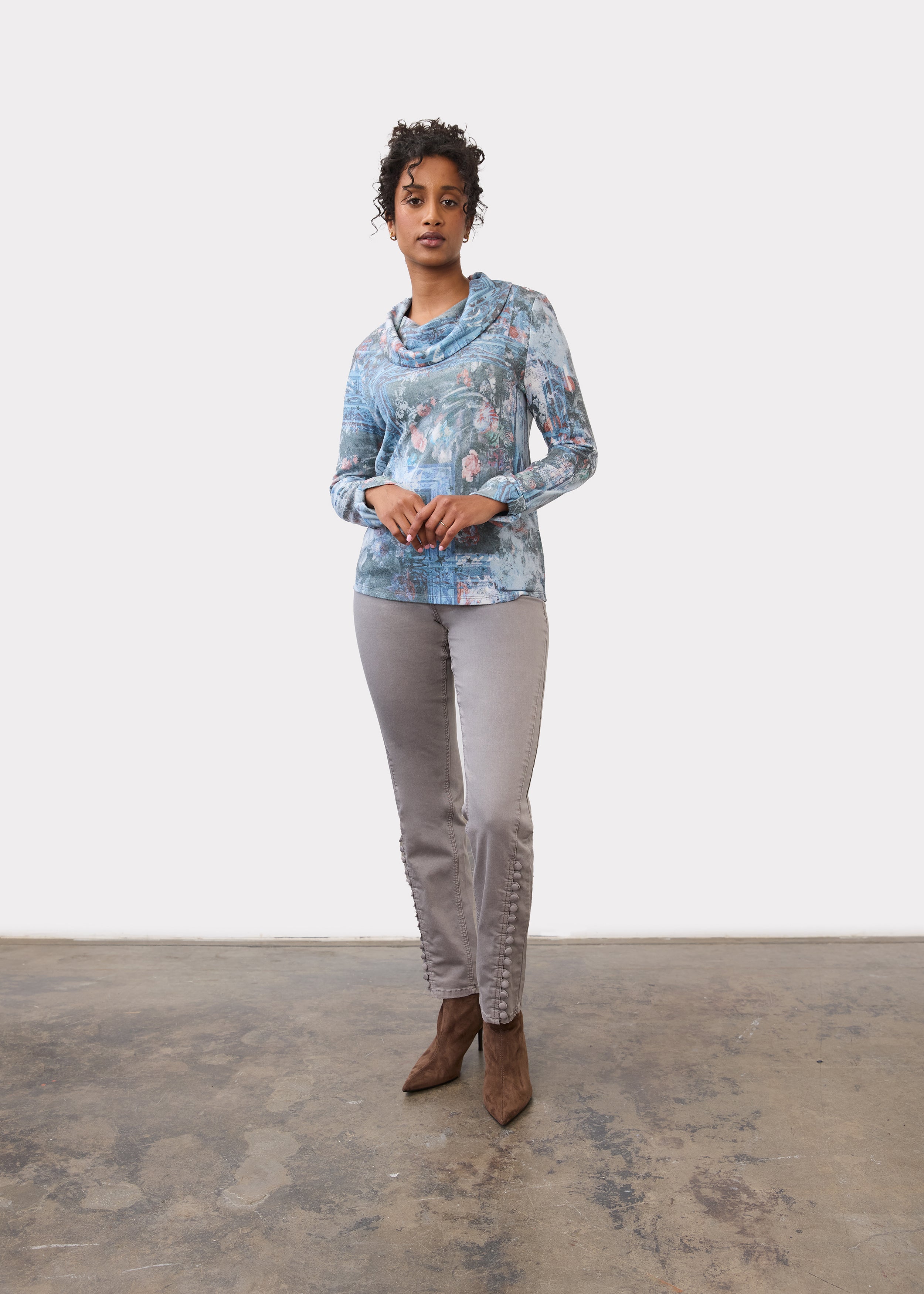 Full view of indigo cowl neck top paired with grey pants and brown boots by French Dressing Jeans (FDJ)