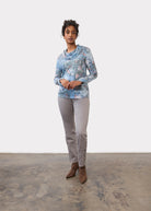 Full view of indigo cowl neck top paired with grey pants and brown boots by French Dressing Jeans (FDJ)