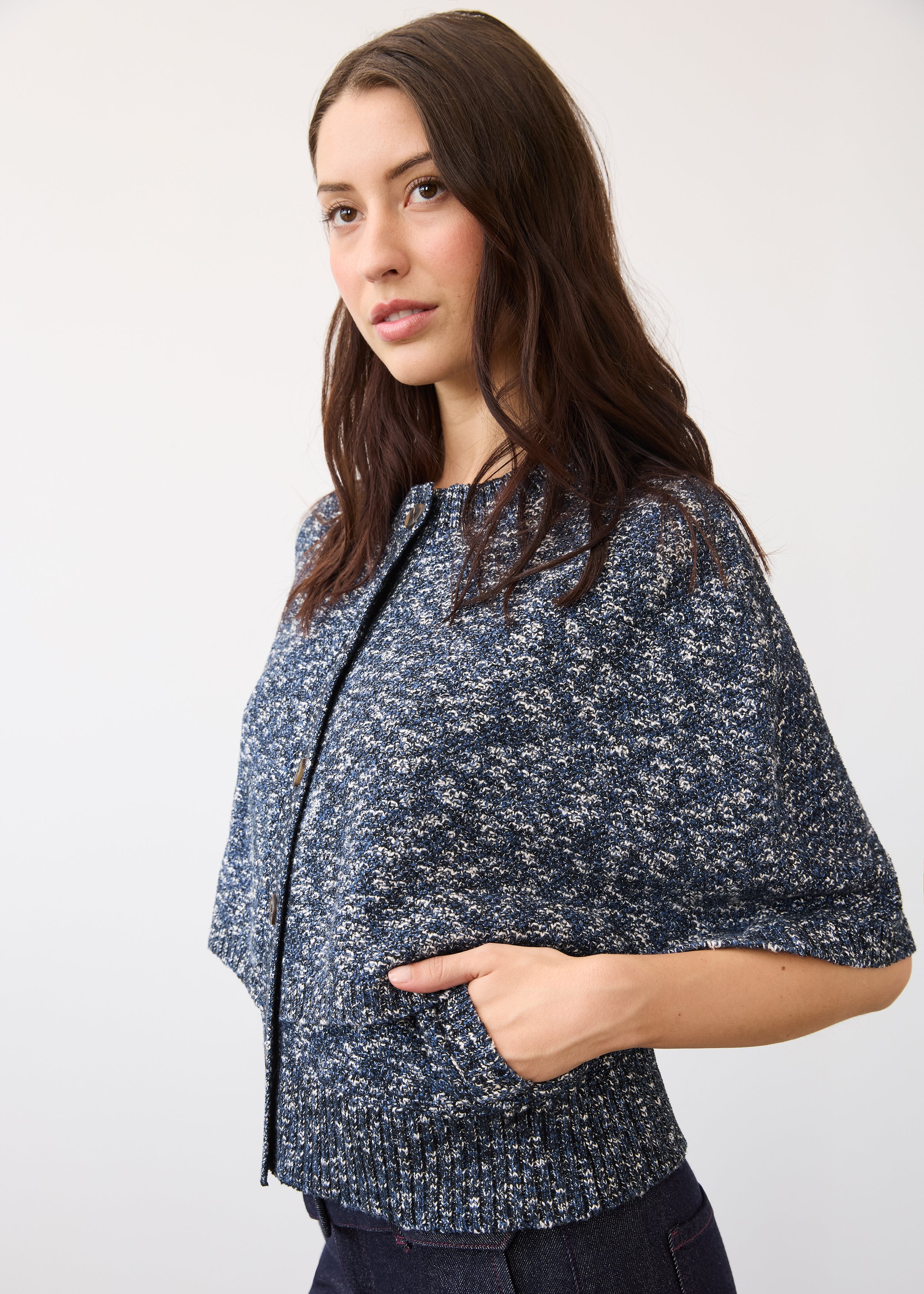 Side profile of a textured blue knit top with dark wash denim highlighting fabric detail and fit by French Dressing Jeans (FDJ)