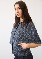 Side profile of a textured blue knit top with dark wash denim highlighting fabric detail and fit by French Dressing Jeans (FDJ)
