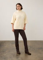 Full view of cream tunic sweater paired with dark pants by French Dressing Jeans (FDJ)