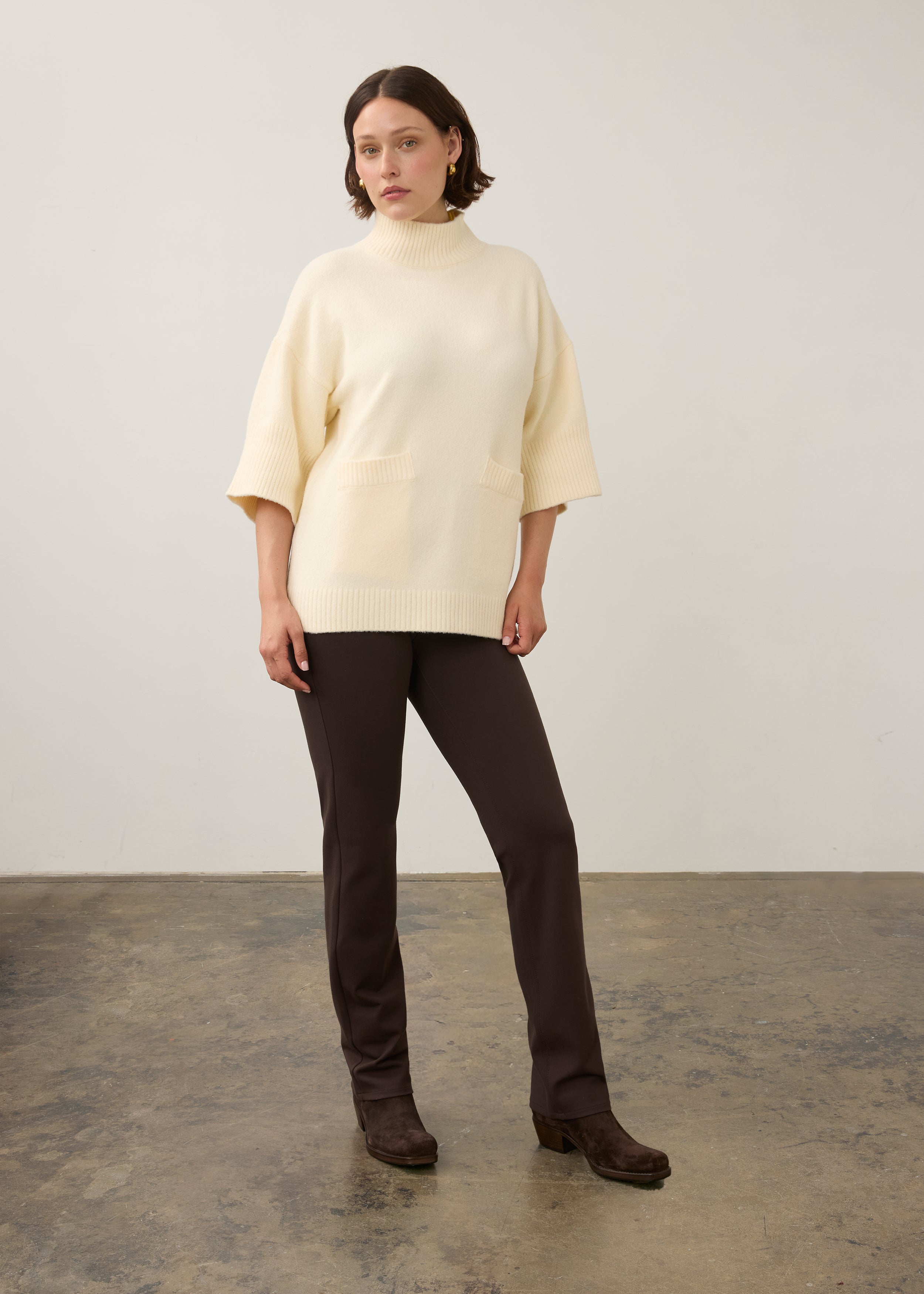 Full view of cream tunic sweater paired with dark pants by French Dressing Jeans (FDJ)