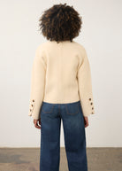 Back view of cream knit cardigan showcasing buttoned cuffs and straight hem by French Dressing Jeans (FDJ)
