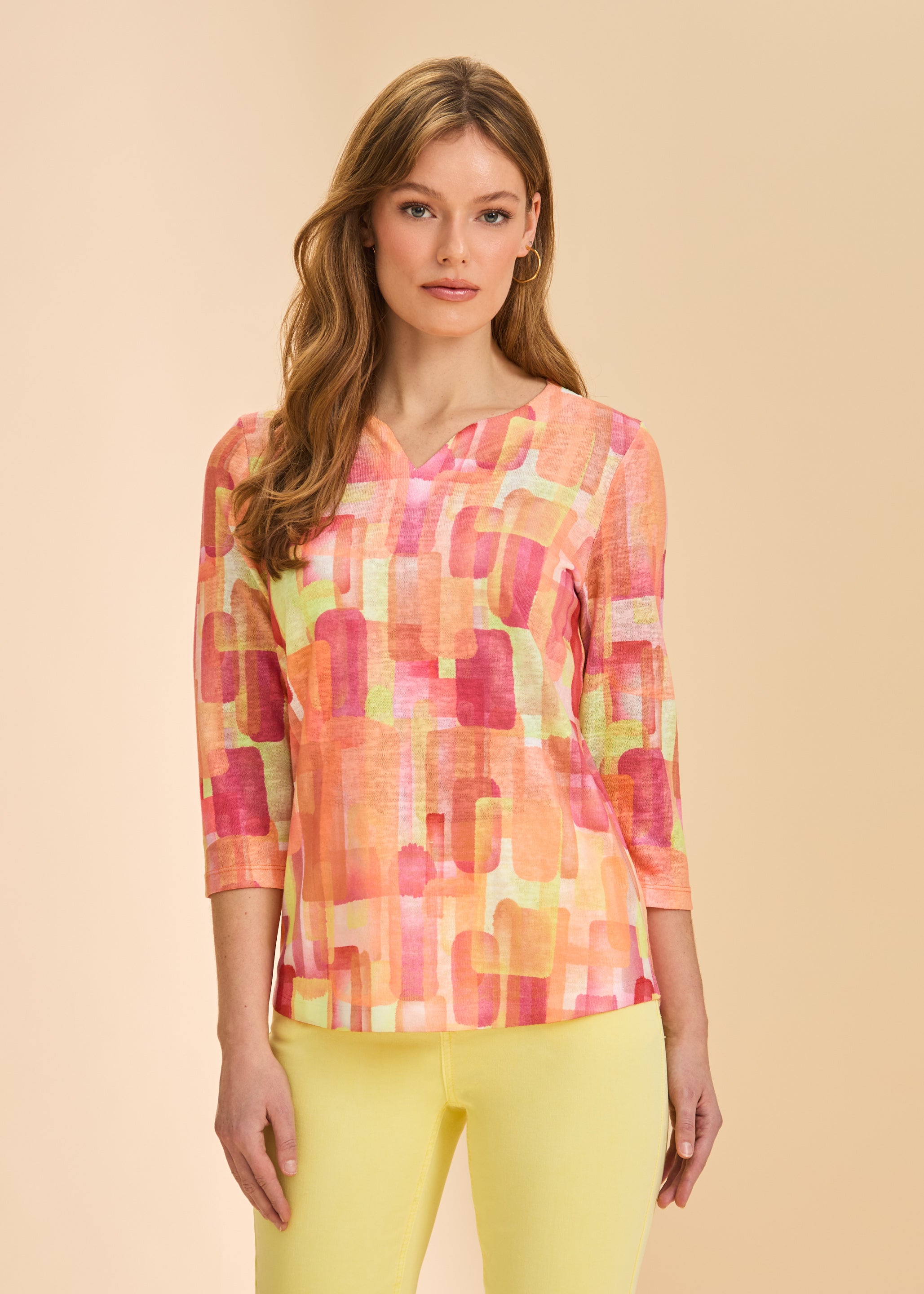 Front view of orange block print 3/4 sleeve V-neck top with yellow pants by French Dressing Jeans (FDJ)