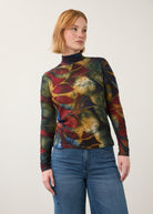 Front view of abstract print top in deep hues, paired with denim jeans by French Dressing Jeans (FDJ)