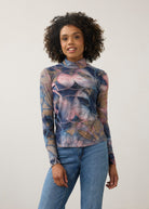Front view of abstract blue and pink print top, paired with denim jeans by French Dressing Jeans (FDJ)