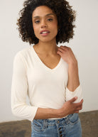 Close-up of cream V-neck top focusing on neckline and soft fabric texture by French Dressing Jeans (FDJ)