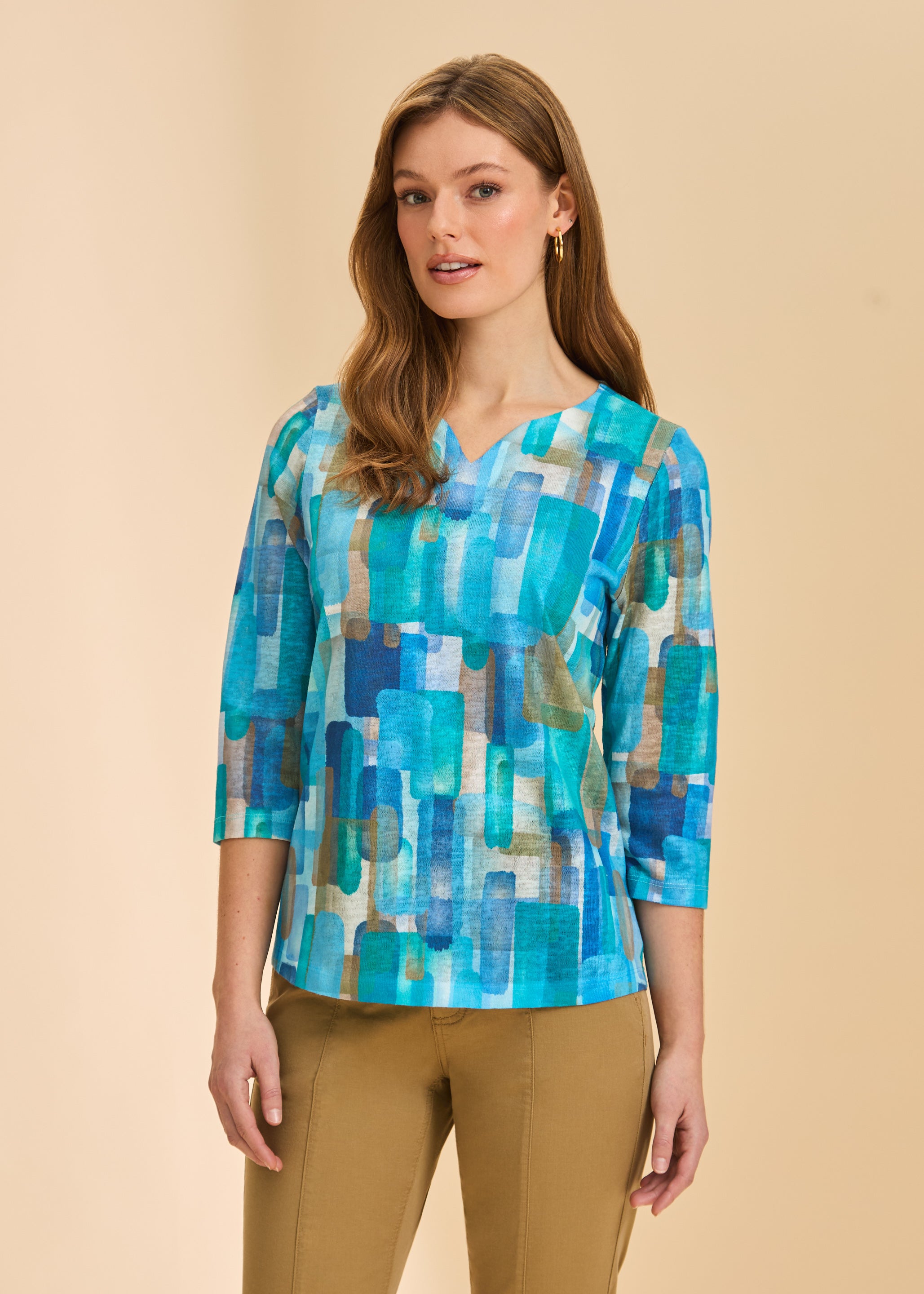 Front view of turquoise block print 3/4 sleeve V-neck top with tan pants by French Dressing Jeans (FDJ)